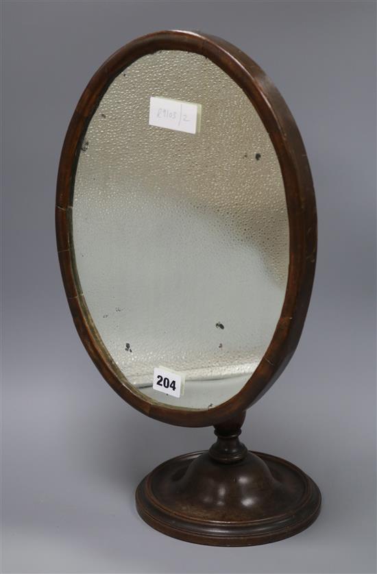 An early 19th century mahogany shaving mirror